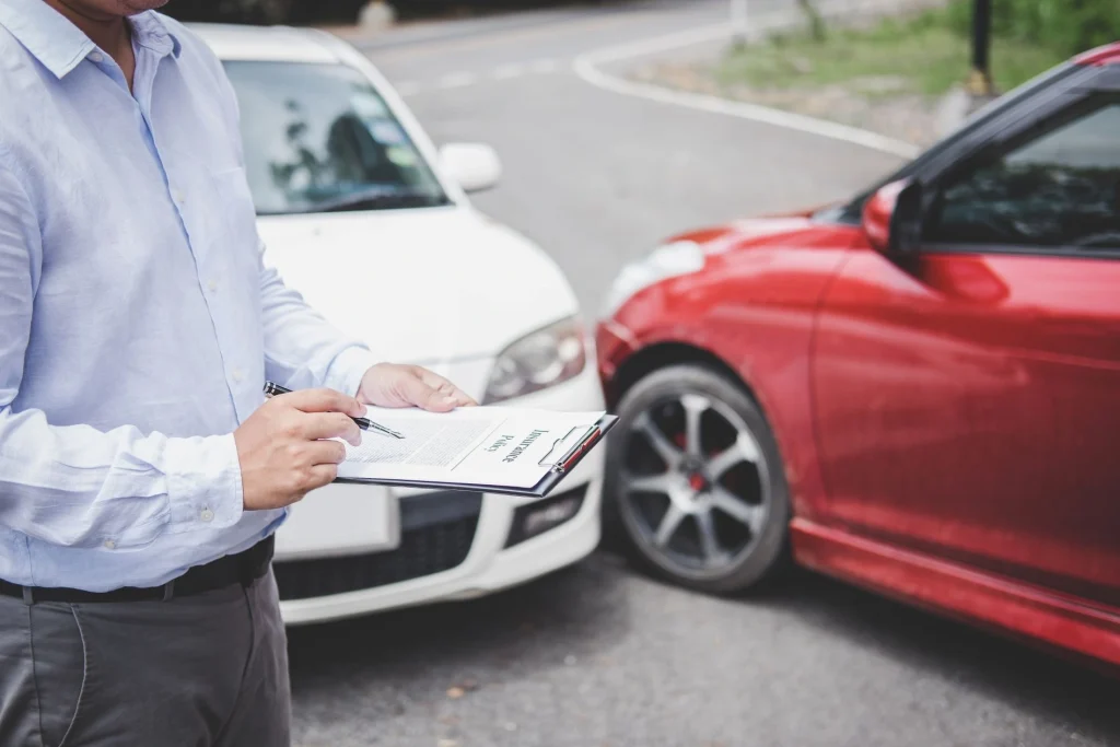 midsection man signing insurance document